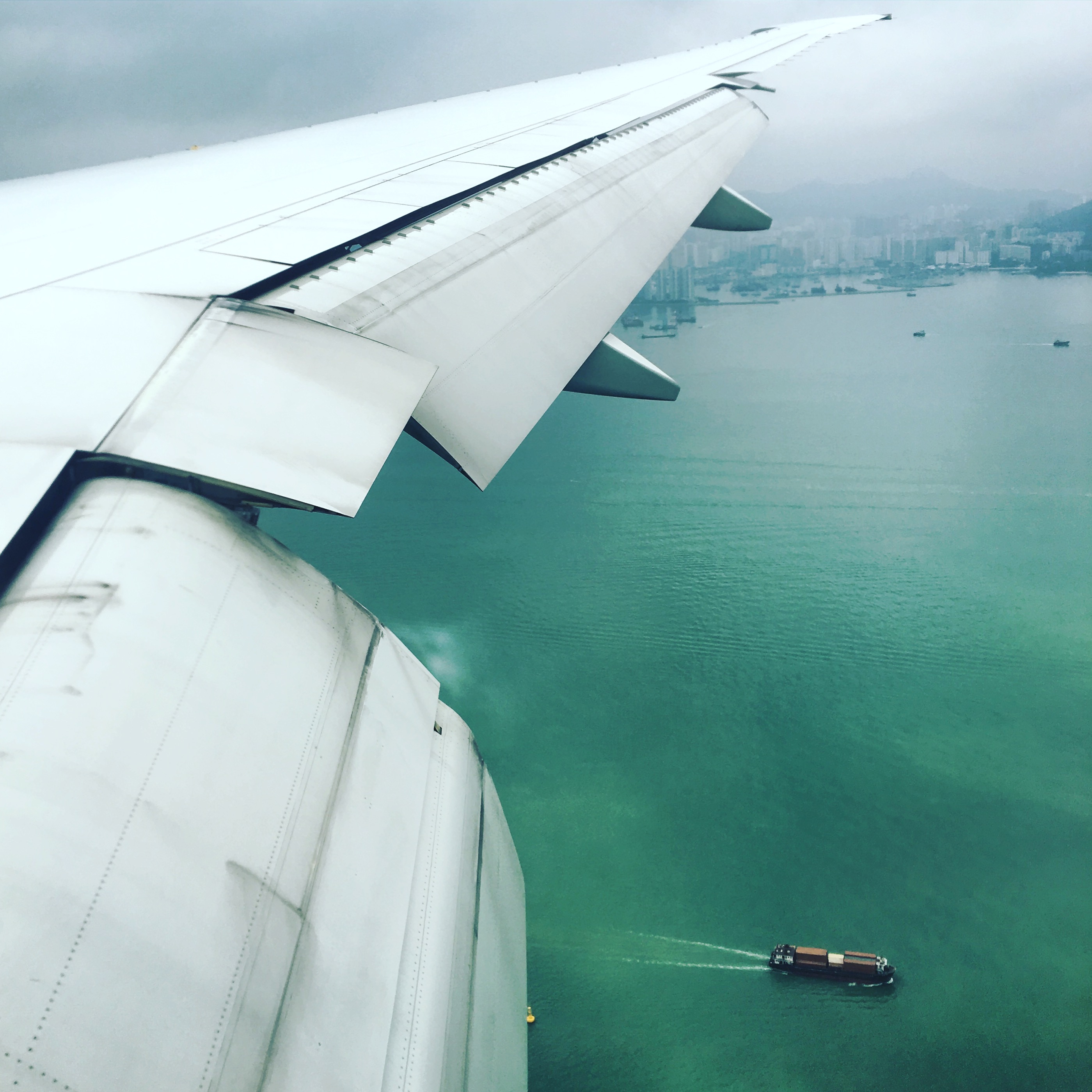 Container ships in the South China Sea visible from airplane about to land at Chek Lap Kok airport.